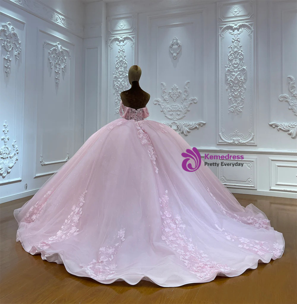 Back view of pink tulle wedding ball gown showing lace up corset and sweeping train