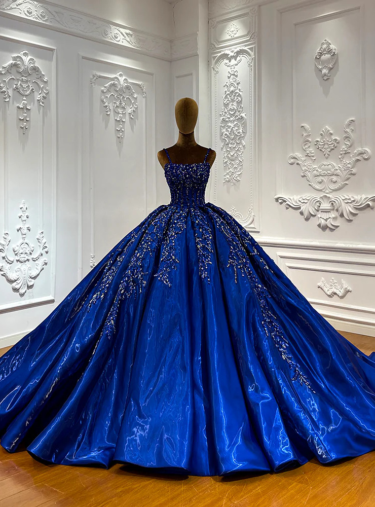 Royal blue satin ball gown with spaghetti straps and cascading beadwork