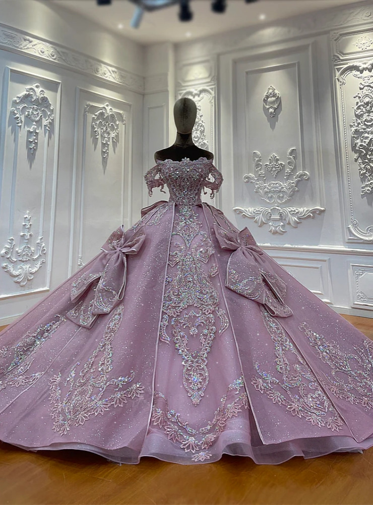 Blush pink tulle ball gown with oversized bows and silver sequin embroidery