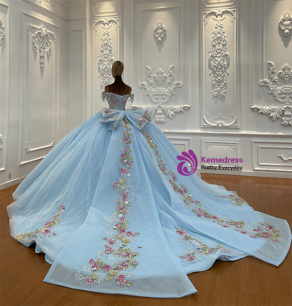 Close-up of multicolour floral appliques and beadwork on blue tulle