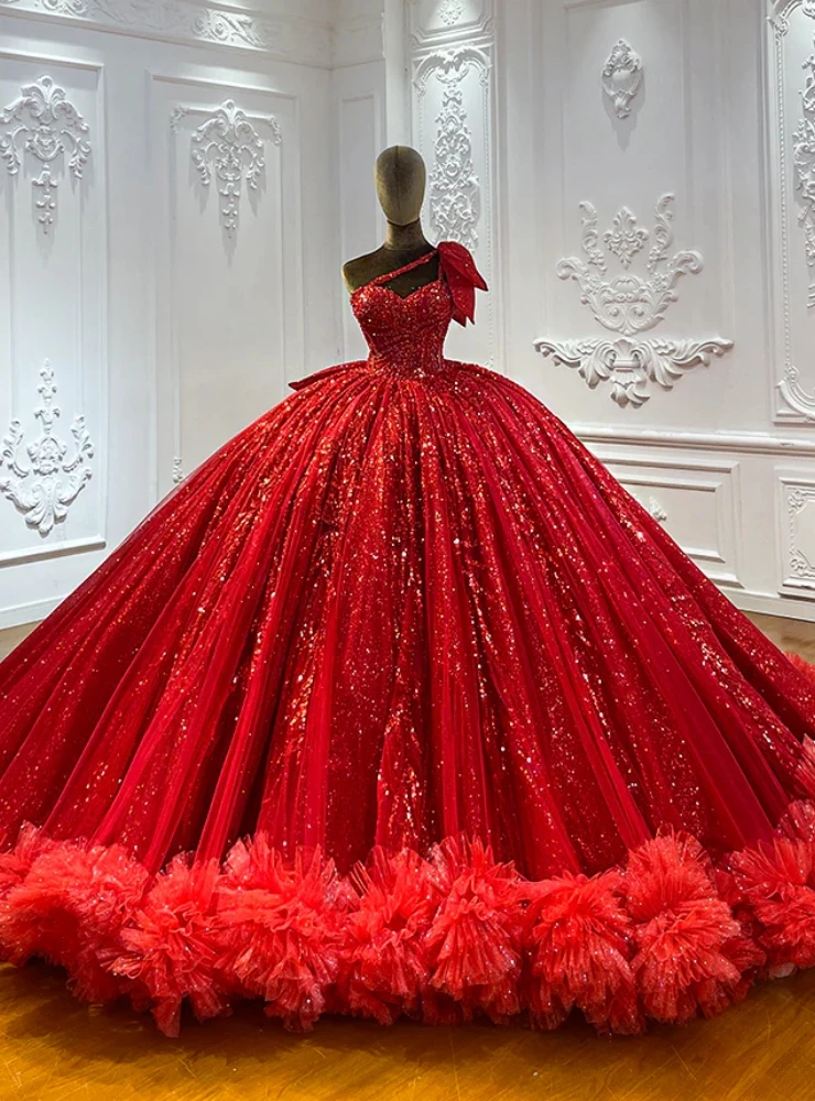 Red tulle sequins appliques formal dress detail showing ruffled tulle hem, vertical sequin panels and off-the-shoulder puff sleeves