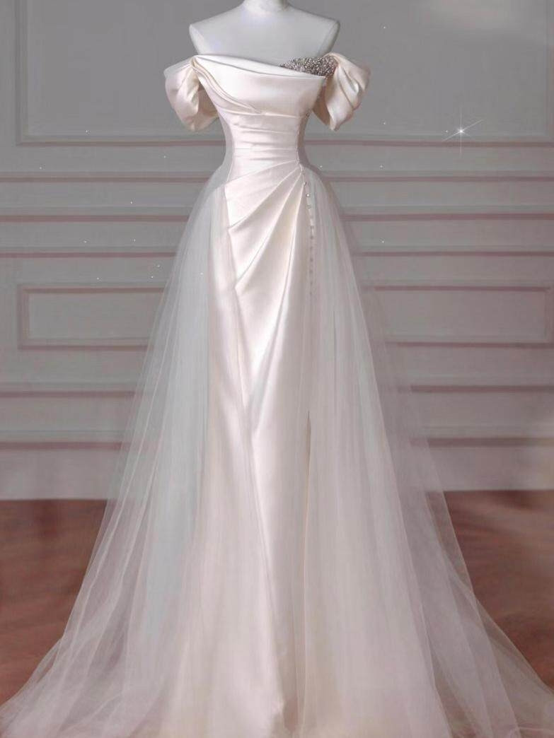 Ivory satin off shoulder beaded wedding dress with diagonal pleats and tulle overskirt