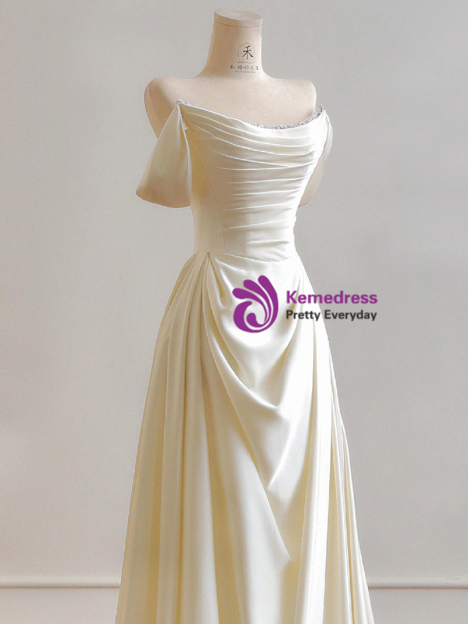 Ivory satin off the shoulder pleated A-line wedding dress with crystal trim and asymmetric draping