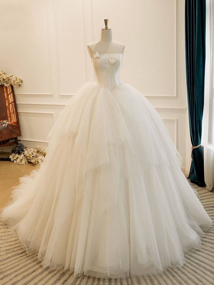 Modern strapless satin wedding ball gown with voluminous layered tulle skirt