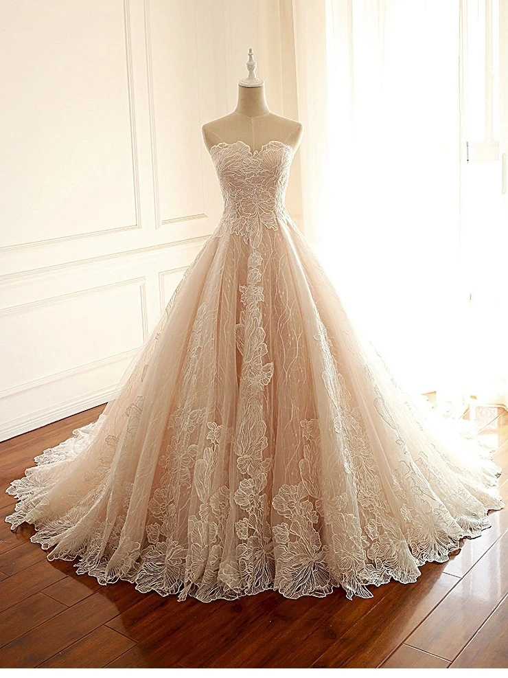 Champagne strapless sweetheart ball gown with satin bodice and flowing skirt