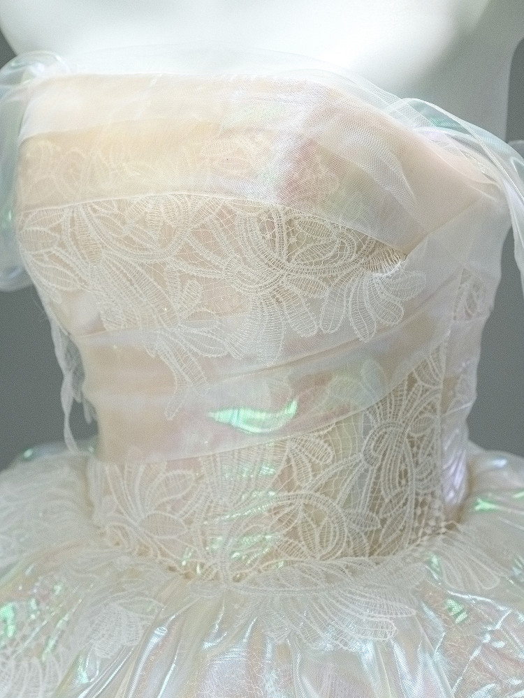 White off the shoulder tiered prom dress with floral lace corset and iridescent layered skirt