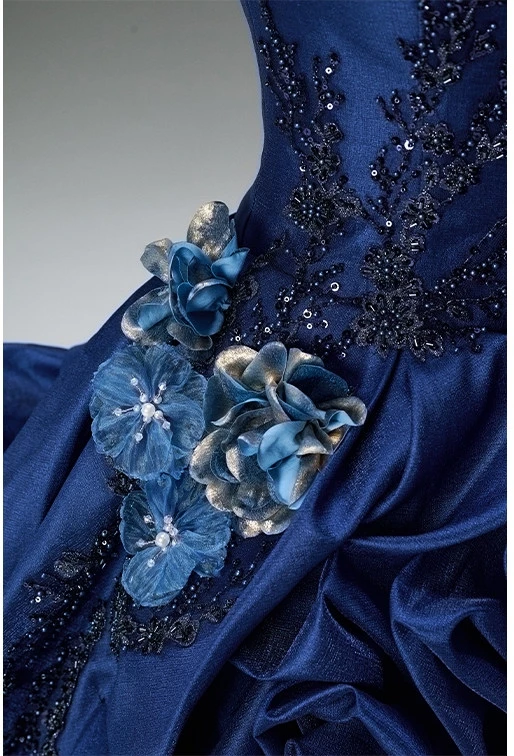 Navy blue floral appliqué quinceanera gown with full length ruffled tulle skirt and train