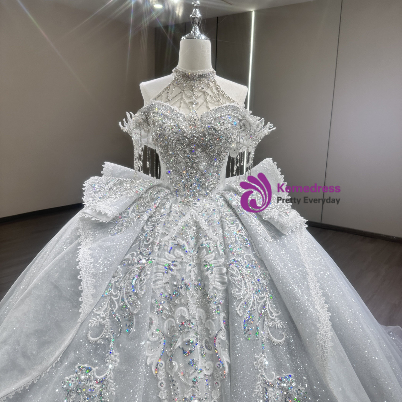 Light blue sequin ball gown wedding dress with dramatic bow and sweeping train