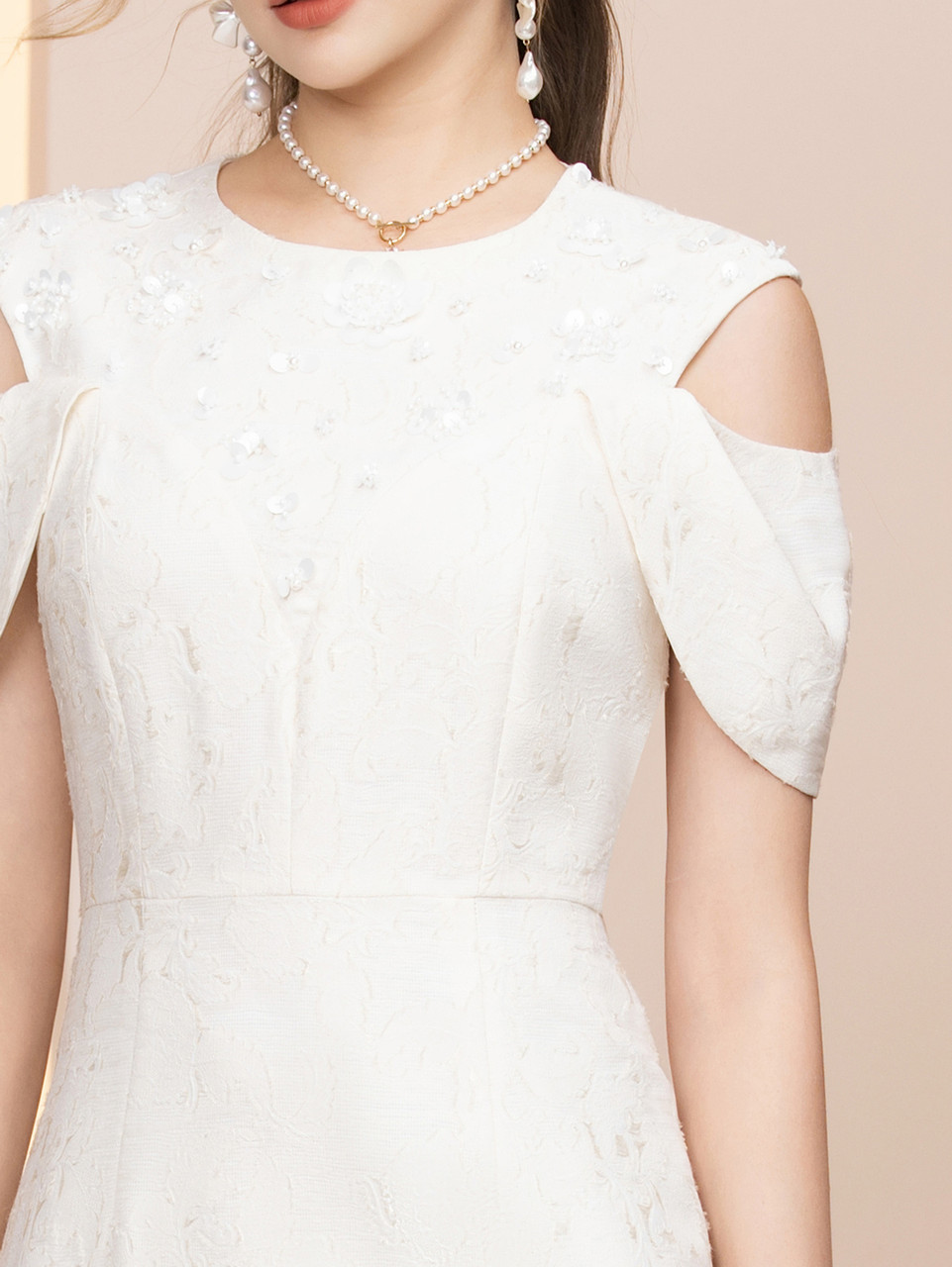 White floral detail on beige mother of the bride tea length dress