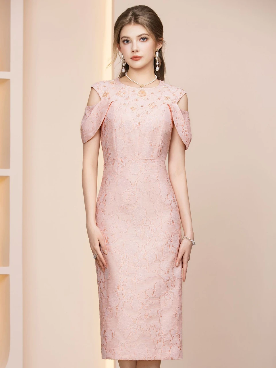 Soft pink tea length mother of the bride dress with floral texture and cold shoulder sleeves