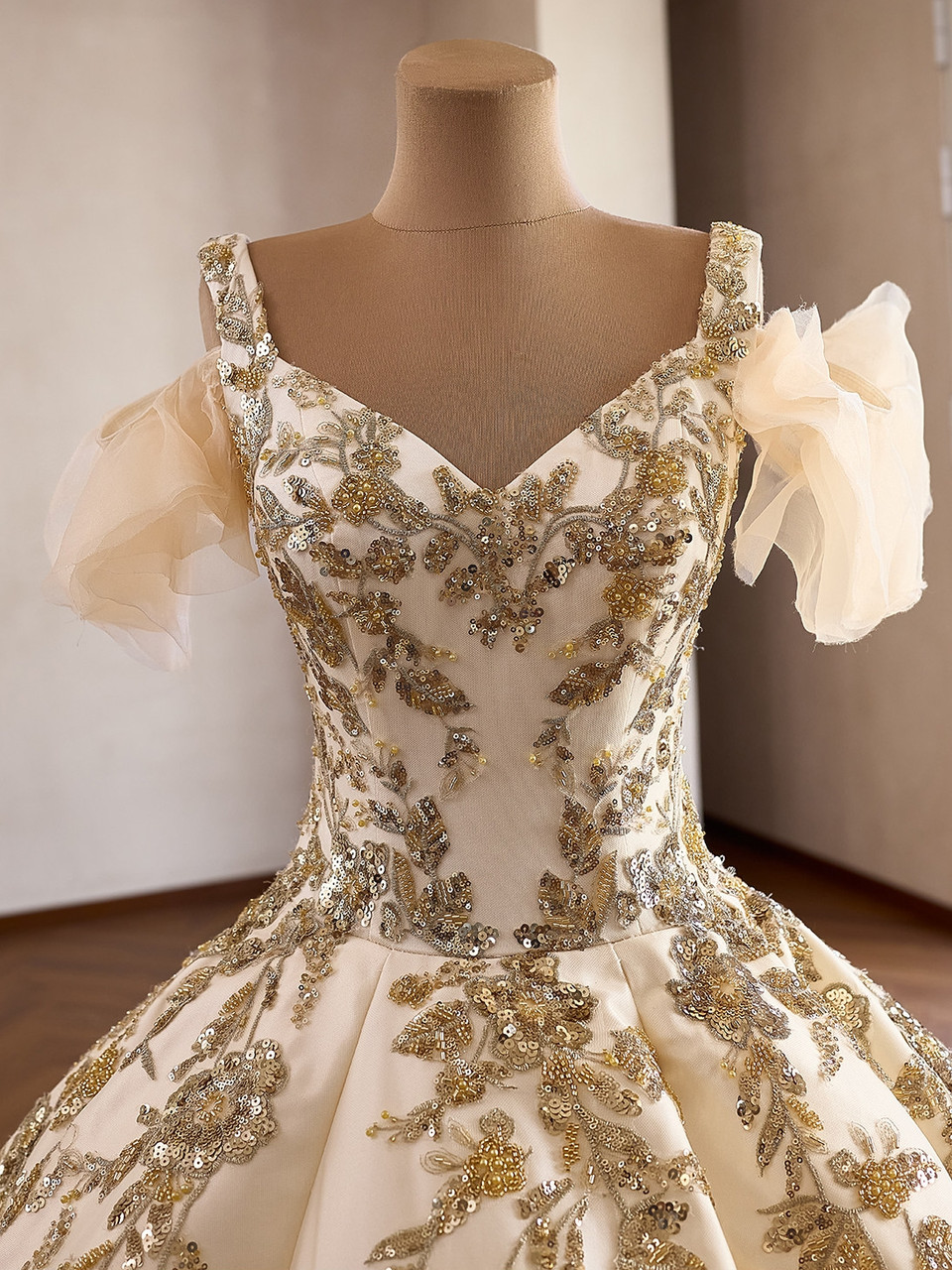 Champagne prom gown with floral appliqué, gold sequin and hand beaded bodice details