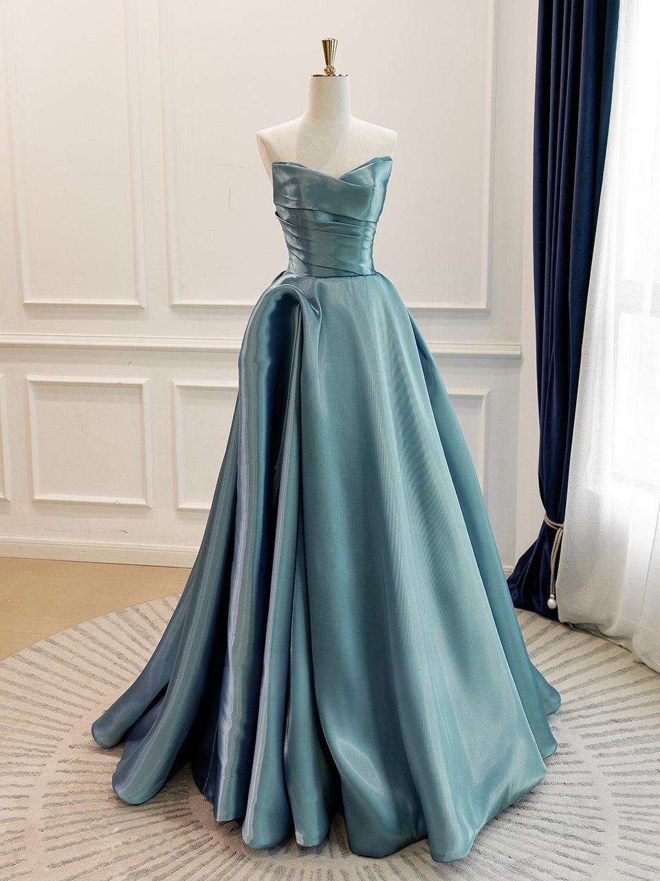Peacock blue satin pleated bodice detail on strapless prom dress