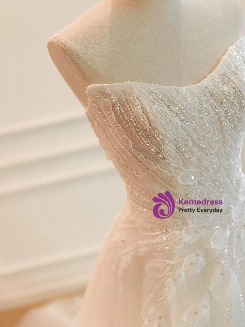 Close view of sweetheart strapless neckline and sparkling beaded sequin bodice on white wedding dress