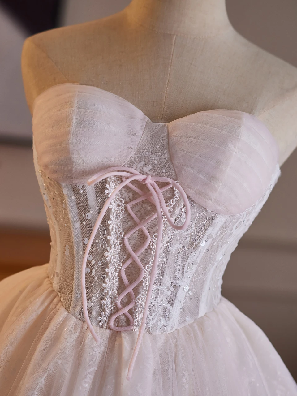 Short pink strapless lace tulle homecoming dress with ruffle skirt