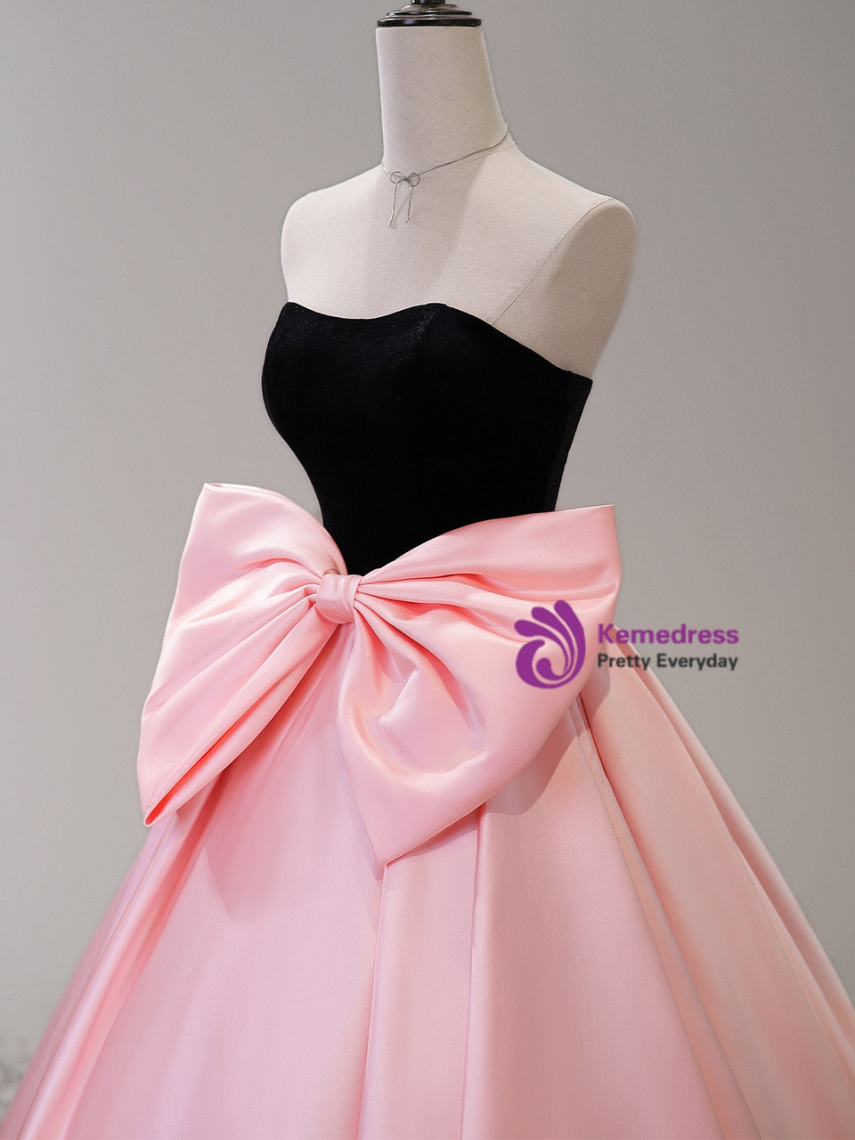 Pink satin full skirt prom gown with oversized waist bow and black velvet bodice