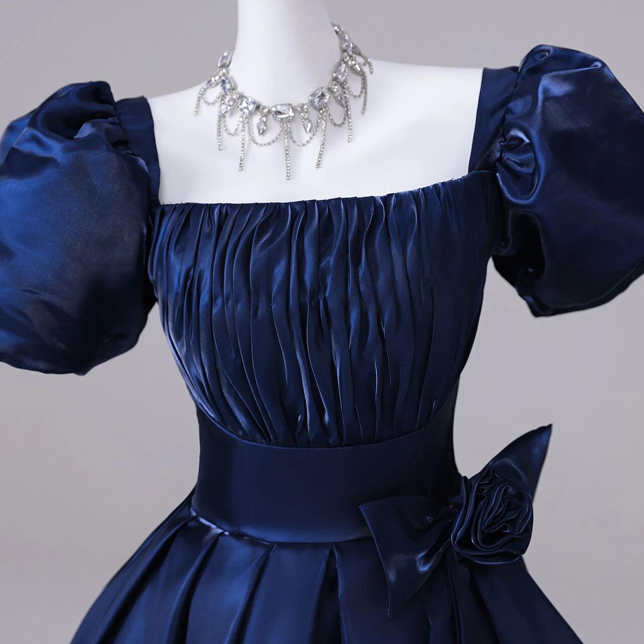 Navy satin pleated A-line quinceanera skirt with puff sleeve bodice