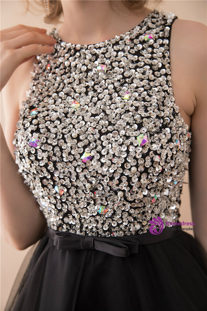 Close up of densely beaded black tulle homecoming dress with silver and iridescent embellishments