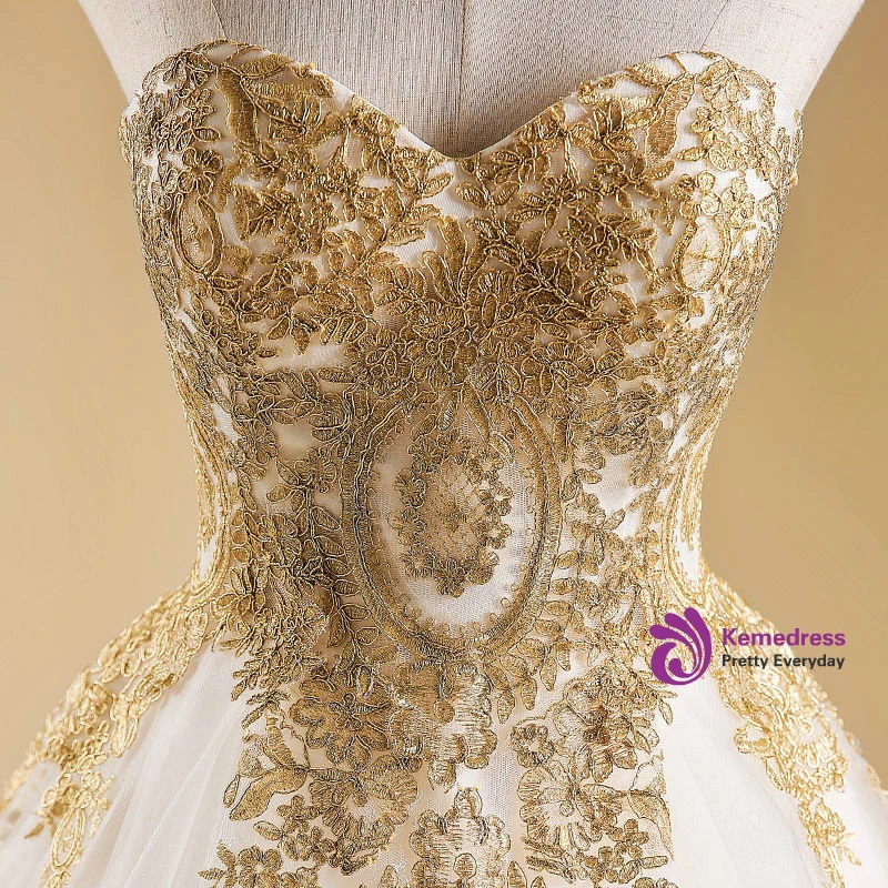 Ivory and gold baroque A line wedding dress with sweetheart neckline and sweep train