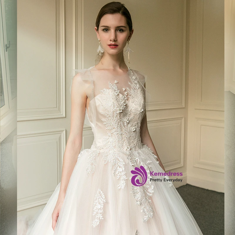 Close-up of botanical appliques on sheer champagne tulle wedding dress bodice