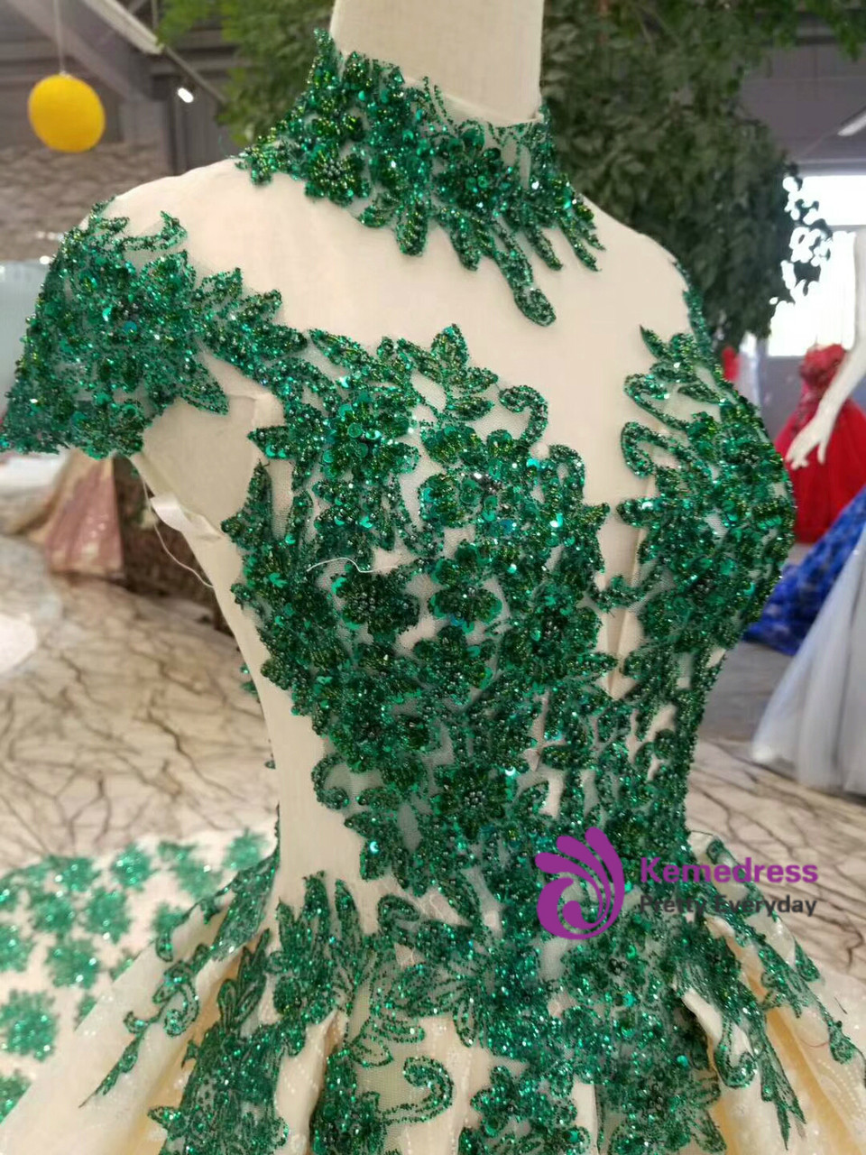 Champagne ball gown wedding dress with emerald green lace appliques high neckline and backless design
