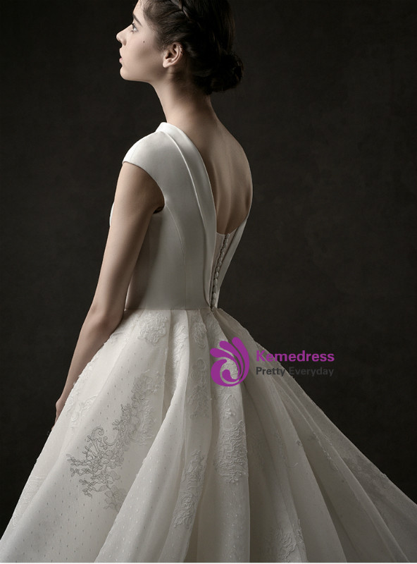 Back view of ivory white ball gown wedding dress with deep V back and corset tie