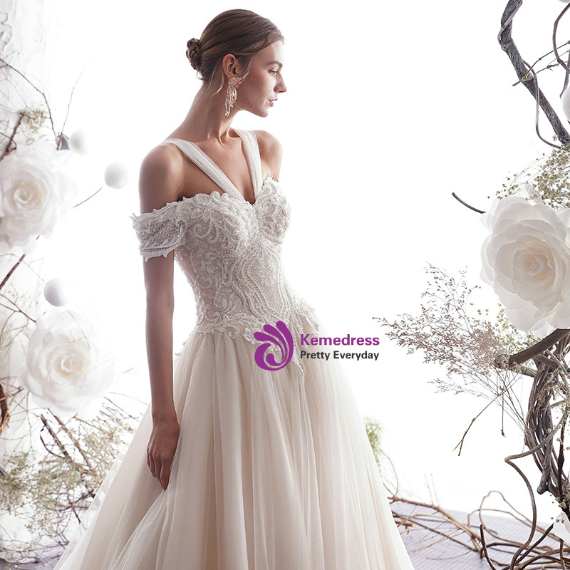 Ivory tulle wedding dress with lace appliqué sweetheart bodice and convertible shoulder detail