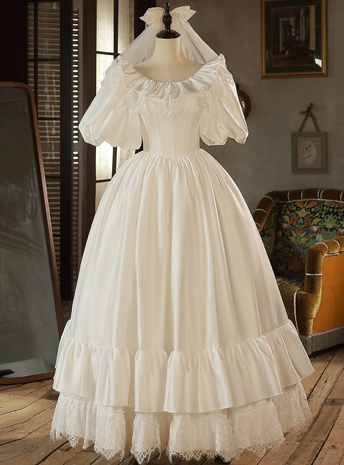 White satin vintage wedding dress with puff sleeves and pearl details