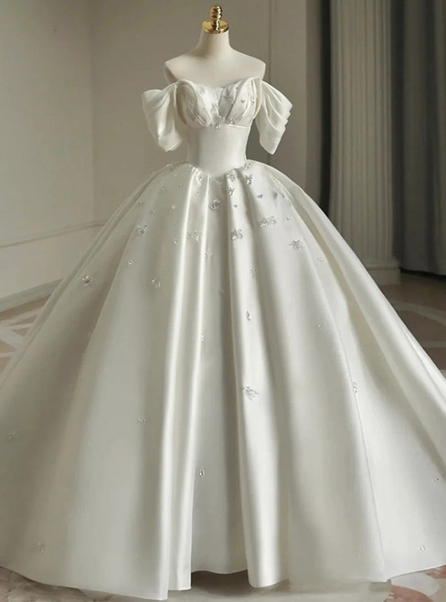 White satin ball gown wedding dress with off-the-shoulder sleeves and beading