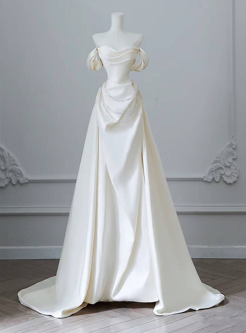 Ivory white off-the-shoulder satin wedding dress with pearl details and A-line skirt