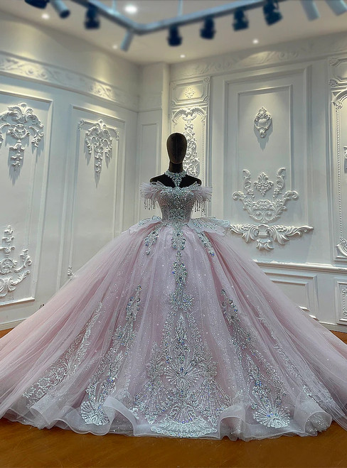 An Old Hollywood-inspired pink ball gown, its off-shoulder bodice richly embroidered with sequins, beads, and floral appliqués that shimmer with timeless elegance.