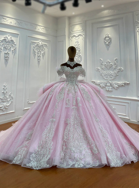 Pink off-shoulder princess ball gown wedding dress with dazzling sequins and beaded lace appliques on a full tulle skirt.
