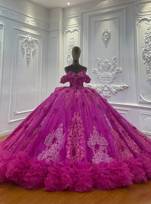 Fuchsia off-shoulder ball gown wedding dress with delicate lace appliques on a full tulle skirt.