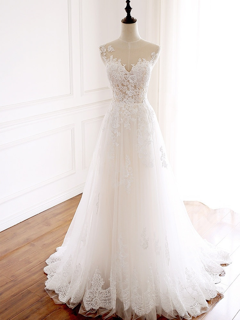 White tulle wedding dress with v-neck and appliqués front view