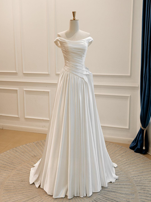 Front view of the white satin A-line pleated bridal gown.