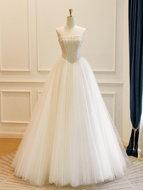 Detail view showcasing the sweep train and the delicate blend of beige and white tones.