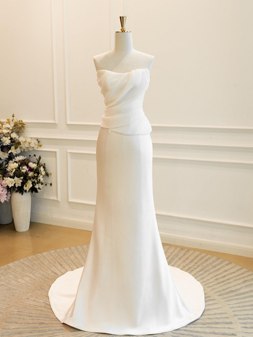 Front view of the stark white satin mermaid gown with a straight neckline and ruched bodice.

