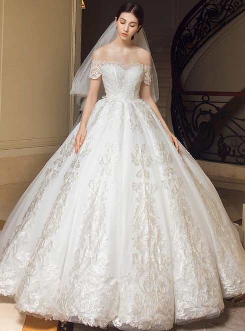 Off the shoulder ball gown wedding dress with lace appliqués and full tulle skirt