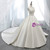 Close-up of the plunging V-neckline and structured satin bodice on a ball gown wedding dress.