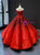 Dramatic red satin Quinceanera ball gown with black floral appliques and off-shoulder sleeves.
