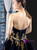 Strapless neckline on navy velvet formal gown with beading