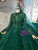Close-up of the delicate beadwork and appliqué details on the bodice and long sleeves of a dark green tulle wedding dress.