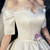 Close up of the sweetheart neckline and ruffled tulle sleeves on a bridal gown