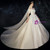 Bride in a satin ball gown wedding dress with a voluminous skirt and chapel train