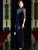 Luxurious navy mother of the bride dress featuring a velvet fabric, zipper back, and delicate appliqué embellishments on the bodice.