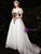 Side view of a white A-line tulle wedding dress, highlighting the square neckline, puff sleeve, and the elegant flow of the skirt