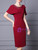 Side view showing the sheath silhouette and decorative bow on a burgundy mother of the bride dress