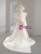 Back of an ivory satin mermaid wedding dress featuring a large statement bow, a stunning focal point for the aisle walk