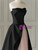Contrast of black satin bodice and pink tulle skirt on prom dress