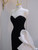 Close up of dramatic black sequin bodice transitioning to white ruffled skirt on prom gown