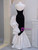 Back view of black and white sequin mermaid prom dress with zipper closure